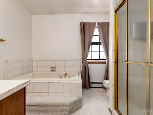 bathroom with a garden tub, toilet, vanity, baseboard heating, and a shower with door