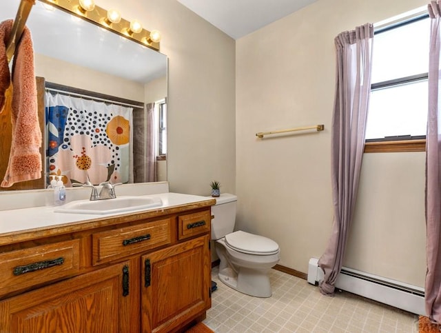 bathroom with toilet, baseboard heating, a wealth of natural light, and vanity