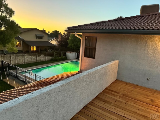 view of pool with a deck, fence, and a fenced in pool