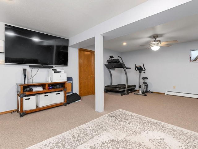 exercise room with carpet floors, a baseboard radiator, baseboards, and a ceiling fan