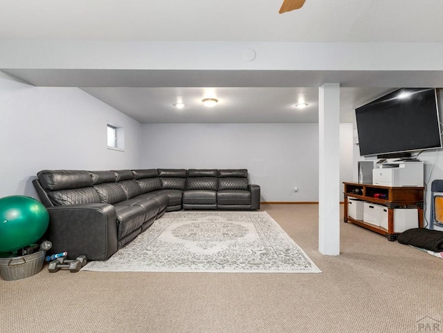 carpeted living area featuring a ceiling fan and baseboards