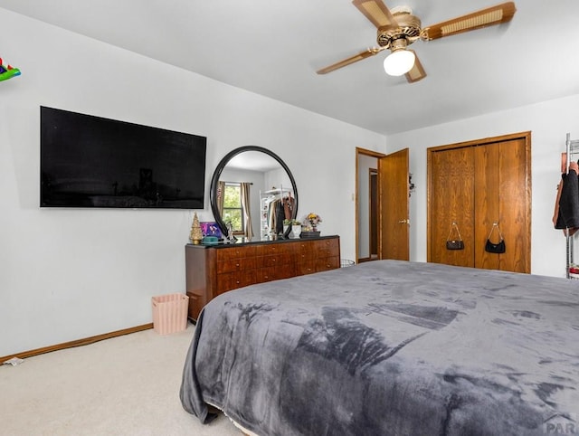 carpeted bedroom featuring ceiling fan and baseboards