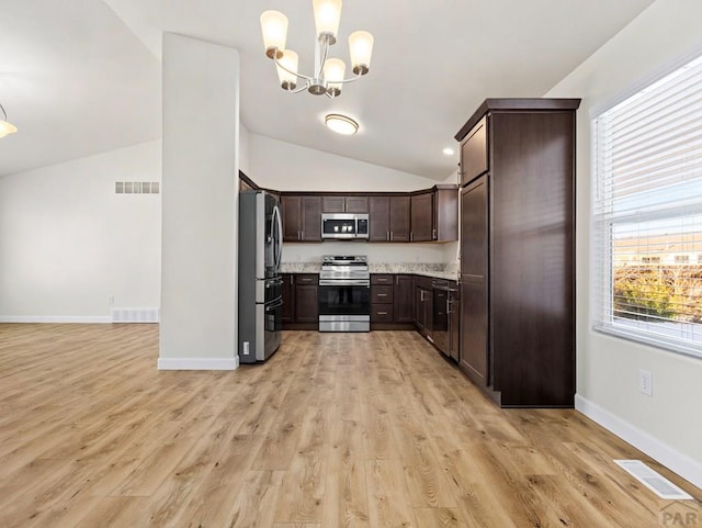 kitchen featuring hanging light fixtures, appliances with stainless steel finishes, visible vents, and dark brown cabinetry