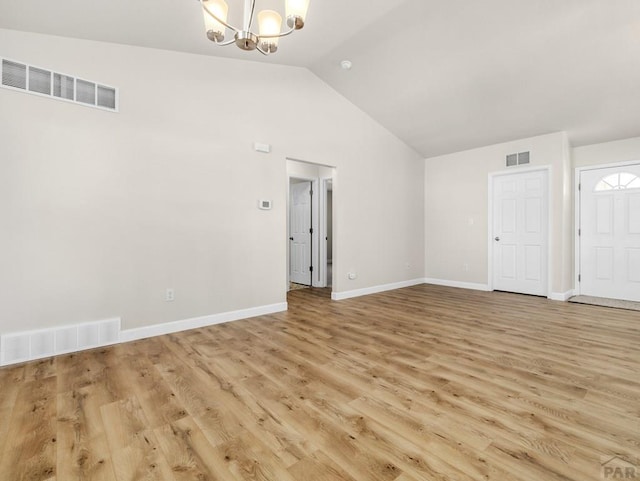 interior space featuring visible vents, light wood finished floors, and an inviting chandelier