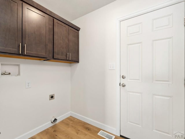 laundry area with visible vents, cabinet space, light wood-style floors, electric dryer hookup, and baseboards