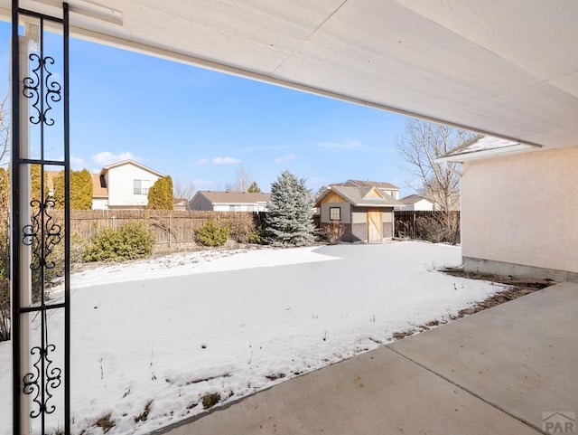 view of patio featuring a fenced backyard, an outdoor structure, and a shed