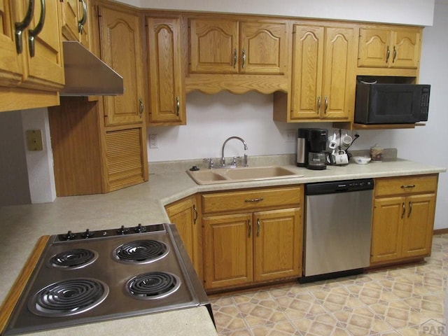 kitchen with brown cabinets, light countertops, a sink, black microwave, and dishwasher