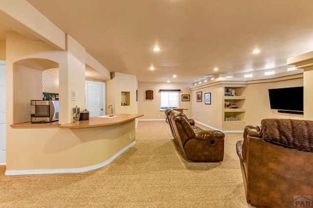 living room featuring light carpet, baseboards, and recessed lighting