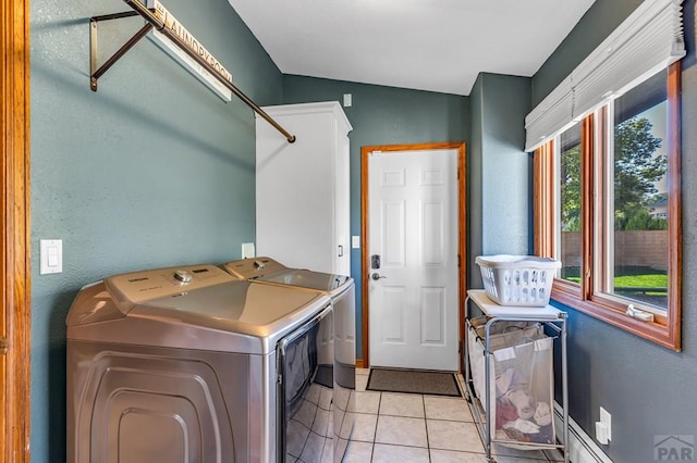 washroom featuring laundry area, a baseboard radiator, light tile patterned floors, and washer and dryer