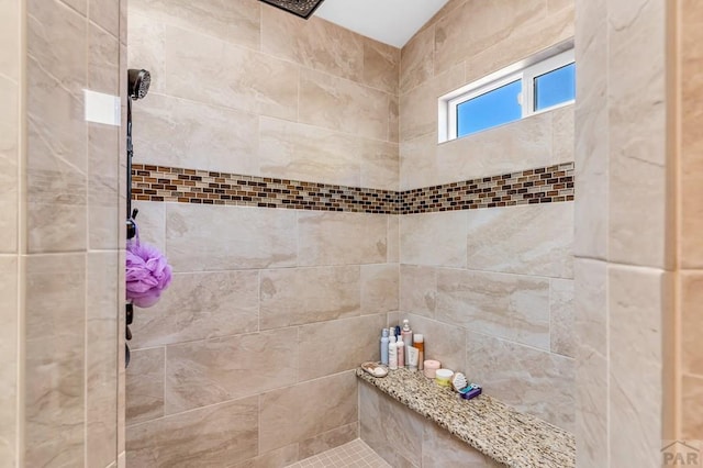 bathroom with a tile shower