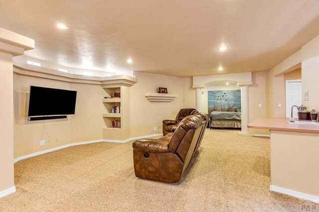 living area with light carpet, ornate columns, baseboards, and recessed lighting