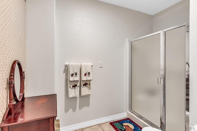 full bathroom with baseboards, a shower stall, and tile patterned floors