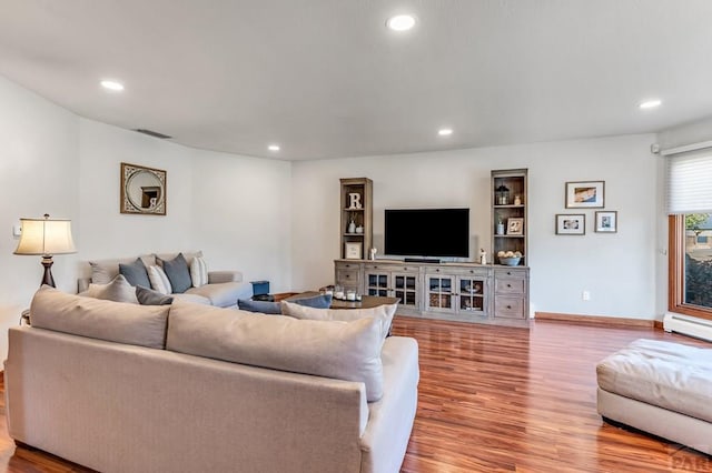 living room with baseboards, visible vents, a baseboard radiator, wood finished floors, and recessed lighting