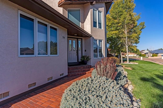 view of home's exterior with a yard, crawl space, and stucco siding