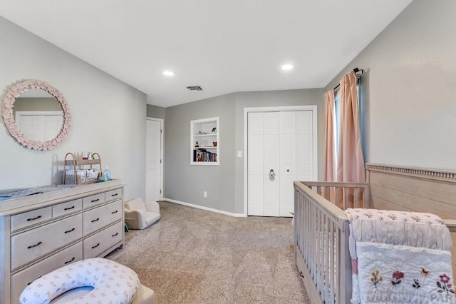 bedroom with a closet, recessed lighting, visible vents, and light colored carpet