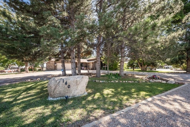 view of front of property featuring a garage and a front yard