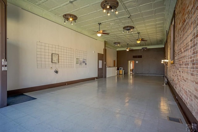 garage with baseboards, visible vents, an ornate ceiling, and ceiling fan