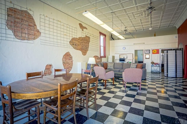 dining space featuring tile patterned floors and ceiling fan