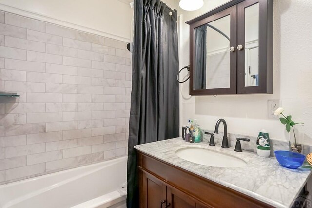 bathroom featuring vanity and shower / tub combo