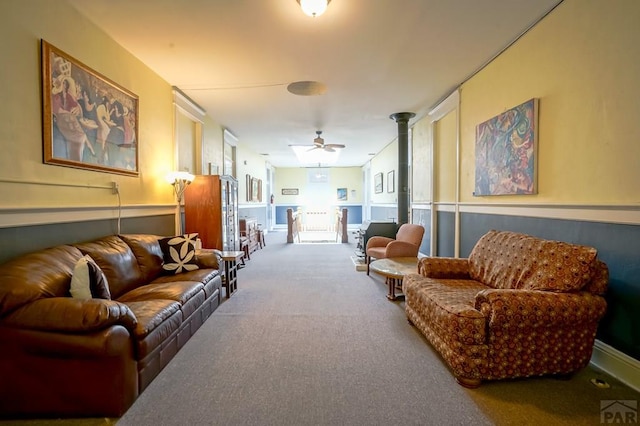 living area featuring ceiling fan and carpet