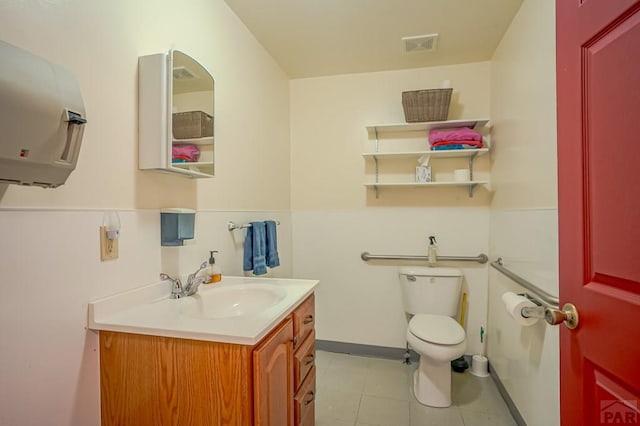 bathroom featuring vanity, tile patterned floors, toilet, and visible vents