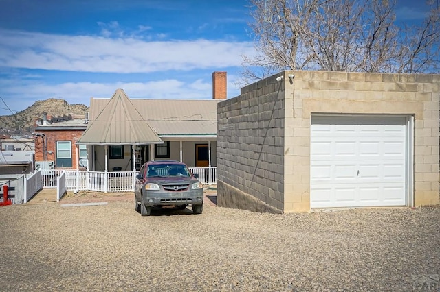 view of front of home with covered porch and a chimney