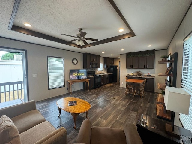 999 Fortino Blvd Unit 138, Pueblo, CO 81008 - living area with dark wood-style flooring, a raised ceiling, ceiling fan, a textured ceiling, and recessed lighting