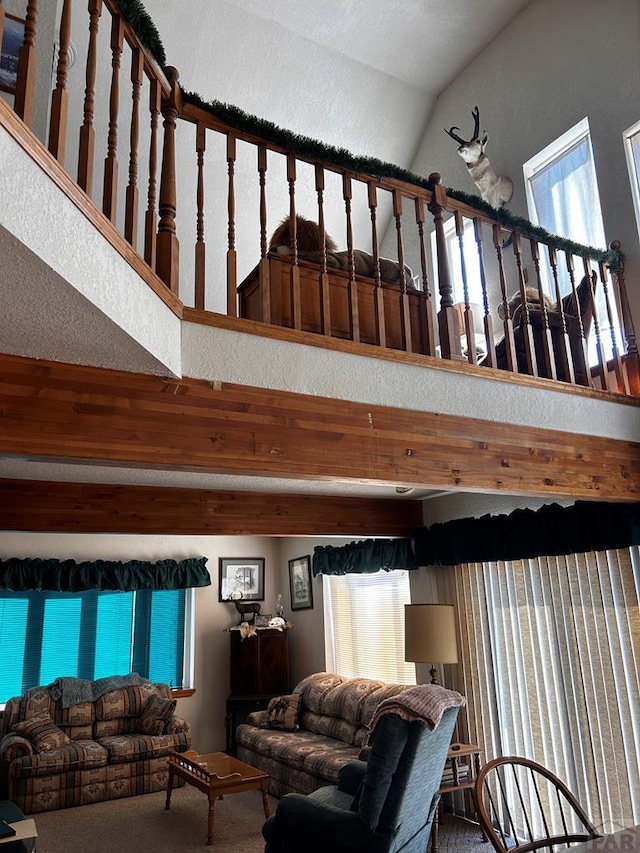 living room with carpet and high vaulted ceiling