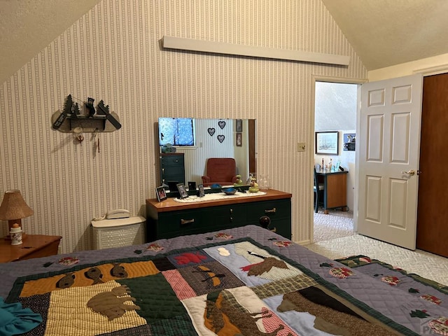 carpeted bedroom with lofted ceiling and wallpapered walls