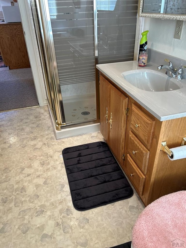 bathroom featuring a stall shower and vanity