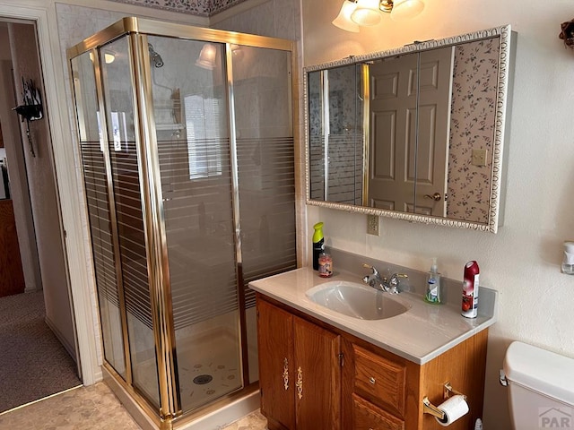full bath with toilet, a stall shower, and vanity