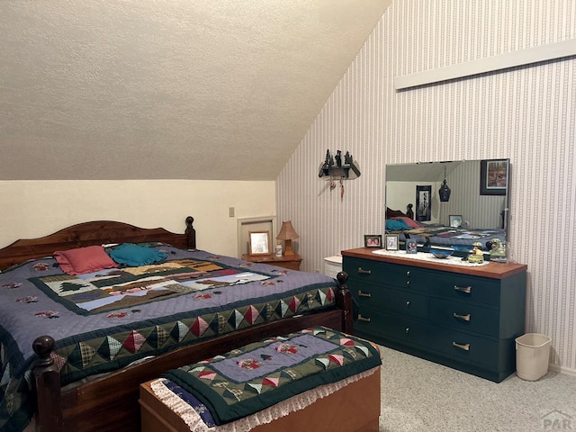 carpeted bedroom with wallpapered walls, vaulted ceiling, and a textured ceiling