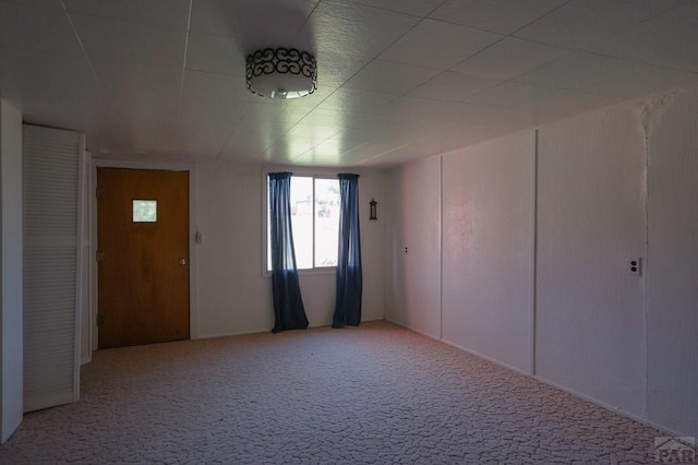 unfurnished room featuring light colored carpet