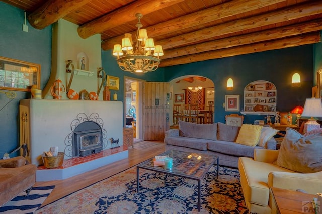 living room with arched walkways, wood ceiling, wood finished floors, a chandelier, and beamed ceiling