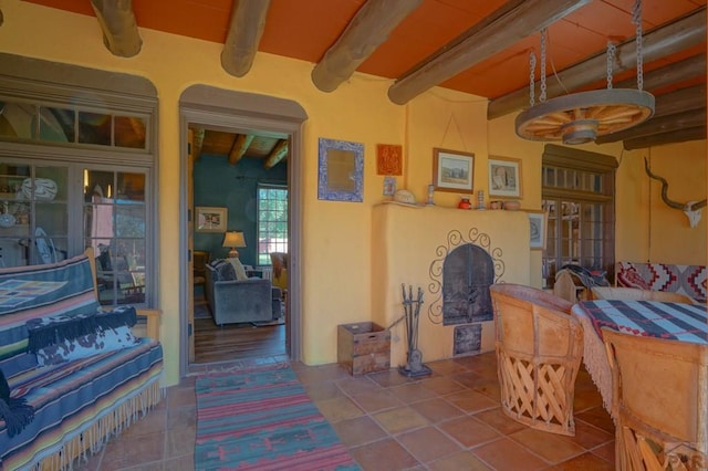 interior space featuring beam ceiling and tile patterned floors