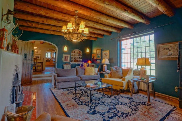 living area with arched walkways, wood ceiling, wood finished floors, beamed ceiling, and a chandelier