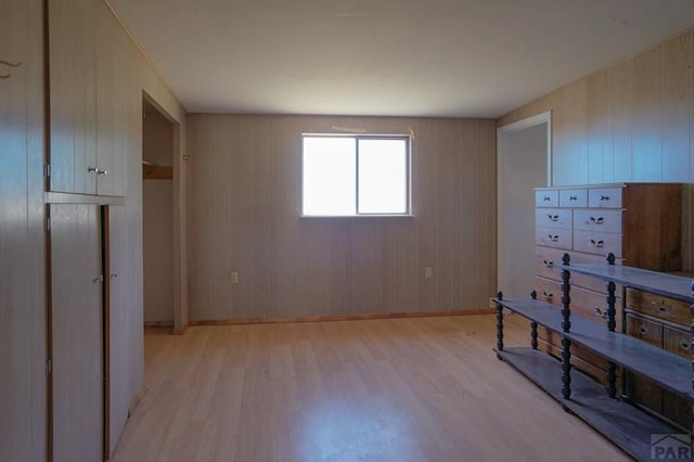 bedroom featuring light wood finished floors and baseboards