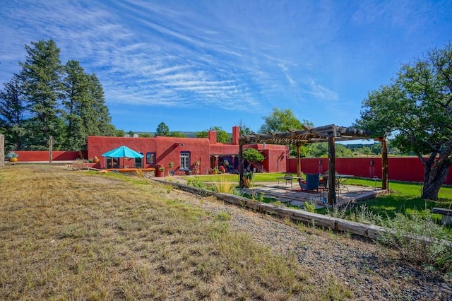 view of yard featuring fence, a patio, and a pergola