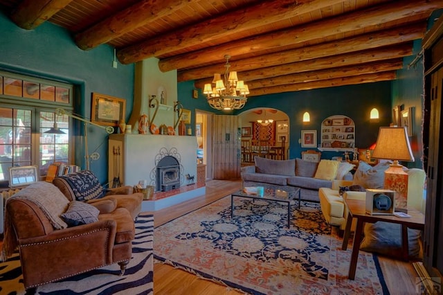 living area featuring arched walkways, wooden ceiling, a notable chandelier, beam ceiling, and light wood finished floors