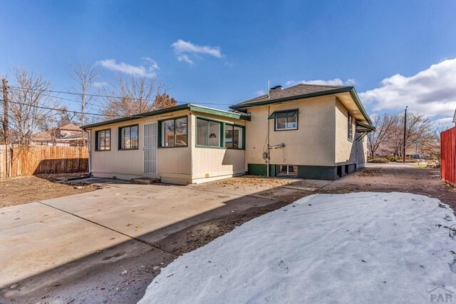 rear view of house featuring a patio area and fence