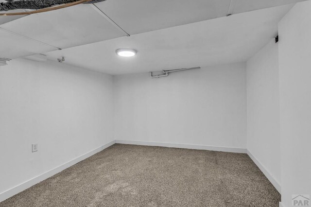 unfurnished room featuring carpet flooring and baseboards