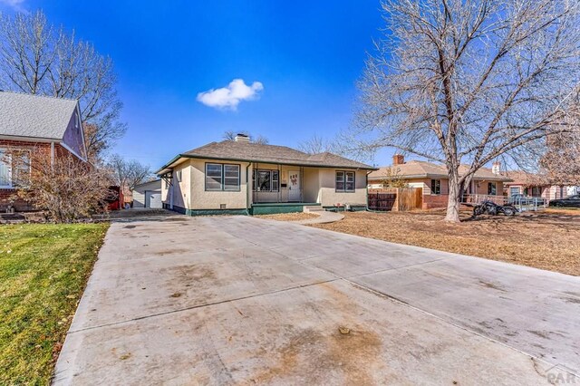 ranch-style house with a garage, fence, a front lawn, and stucco siding