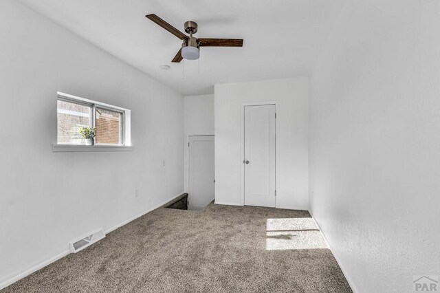 unfurnished bedroom with carpet, visible vents, ceiling fan, and baseboards