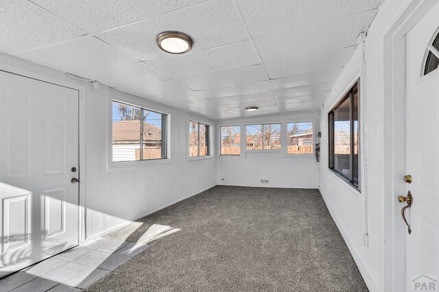 unfurnished sunroom with a drop ceiling