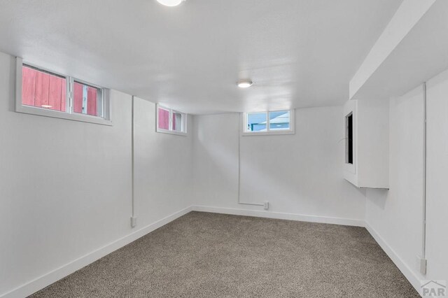 basement featuring carpet floors and baseboards