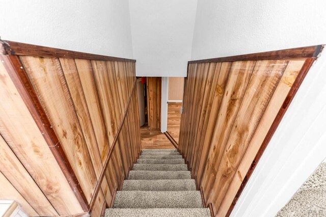 stairs featuring wood finished floors