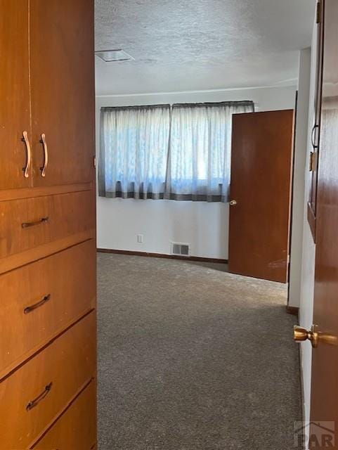 1640 Wabash Ave, Pueblo, CO 81004 - unfurnished bedroom with carpet flooring, a textured ceiling, and baseboards