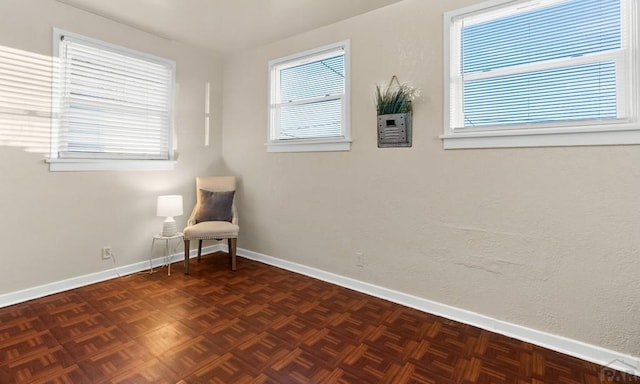 unfurnished room with baseboards