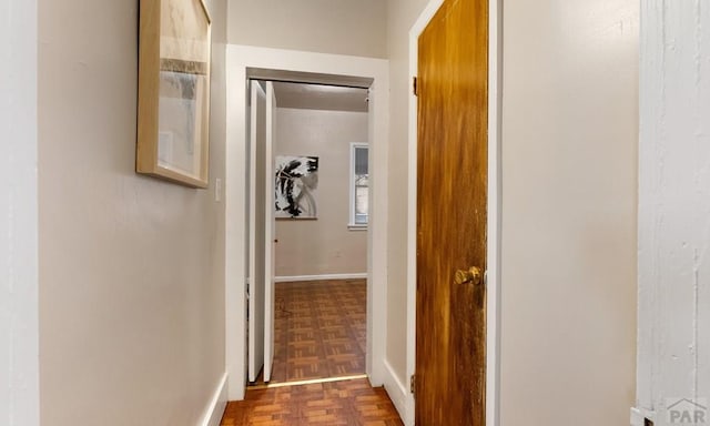 hallway featuring baseboards