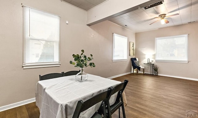 dining room with ceiling fan, baseboards, and wood finished floors